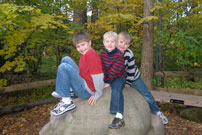 image of James, Will and Charlie on a rock at the Museum of Natural History in Cleveland