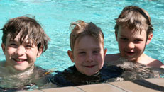 image of James, Will and Charlie in a swimming pool