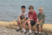 image of James, Will and Charlie sitting by Lake Ontario