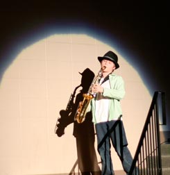 James Anderson playing his sax in spotlight