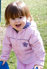 girl shouting with joy before going down the slide