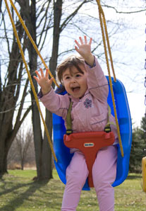 girl screaming while swinging through the air