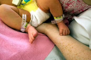 new mom holding baby in the hospital