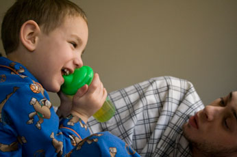 boy waking his brother up