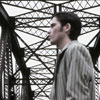 young man standing on bridge