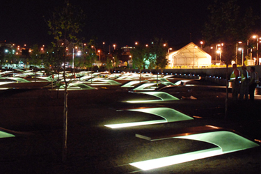 A night time picture of the benches that make up the Pentagon Memorial