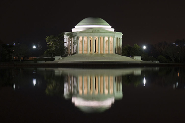 A night time shot of the Jefferson Memorial taken directly in front, but across the Tidal Basin.