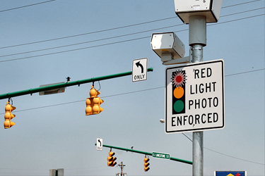 red light camera with sign