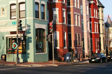 street corner depicting the traffic signals on poles on the corner