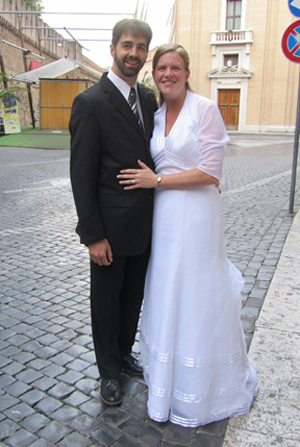 Andrew and Barb in wedding attire standing outside of St. Peter's Square