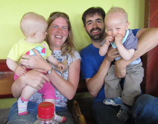 Andrew and Barb struggle to pose with two  babies.