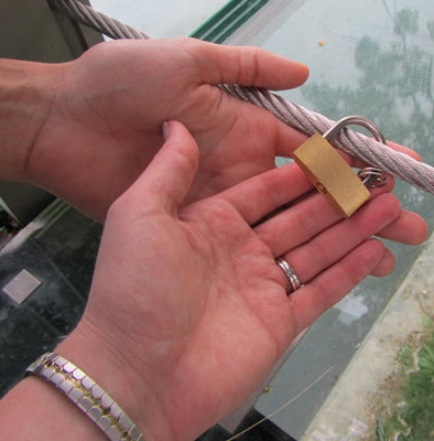 Andrew and Barb attaching a lock to the bridge as a  symbol of eternal love.