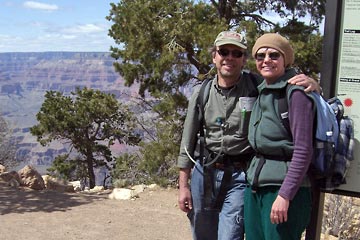 Al and Joanne next to trail sign at rim