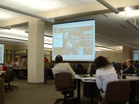 View of classroom during training session showing speaker in the distance.