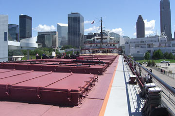 Deck of Wm. Mather, looking aft with Cleveland skyline in background