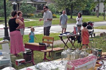 Group of people standing around at yard sale