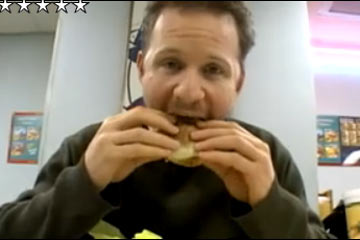 Morgan Spurlock eating a hamburger