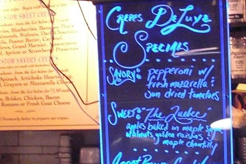 Specials menu board at Crepes Deluxe stand