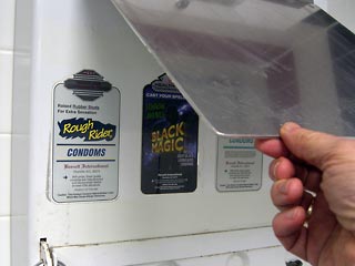 Piece of aluminum covering condom dispenser