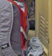 Red backpack in front of locker