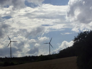 Two wind turbines on a hilllside