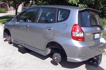 Honda Fit with all four wheels removed