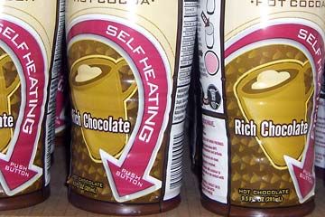 Cans of self heating hot cocoa on shelf