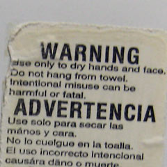 Warning on towel dispenser in men's room