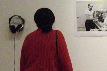 Headphones hanging on white gallery wall