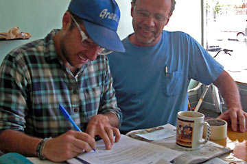 Alex signing loan agreement