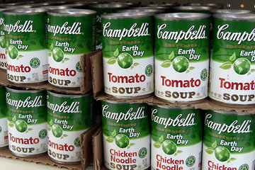 Shelves lined with green cans of Campbell's Tomato Soup