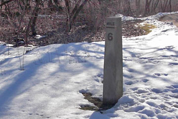 Stone milepost with number 6 on it.