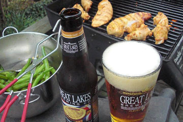 Beer in glass, chicken on grill