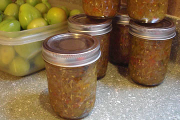Jars of green tomato relish on counter