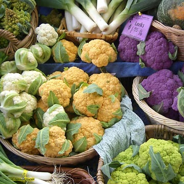 Baskets of orange, yellow, green and purple cauliflowers