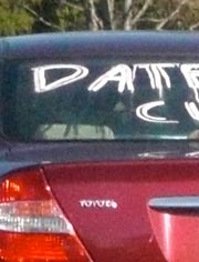 Car with 'Dateless. Cute' written on window
