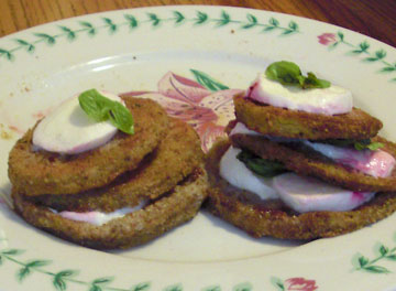Eggplant stacks makde with fresh mozzarella, basil and oven-baked eggplant slices, on a plate
