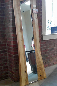 Tall narrow wooden framed mirrro