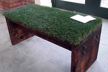Wooden bench covered with artificial turf